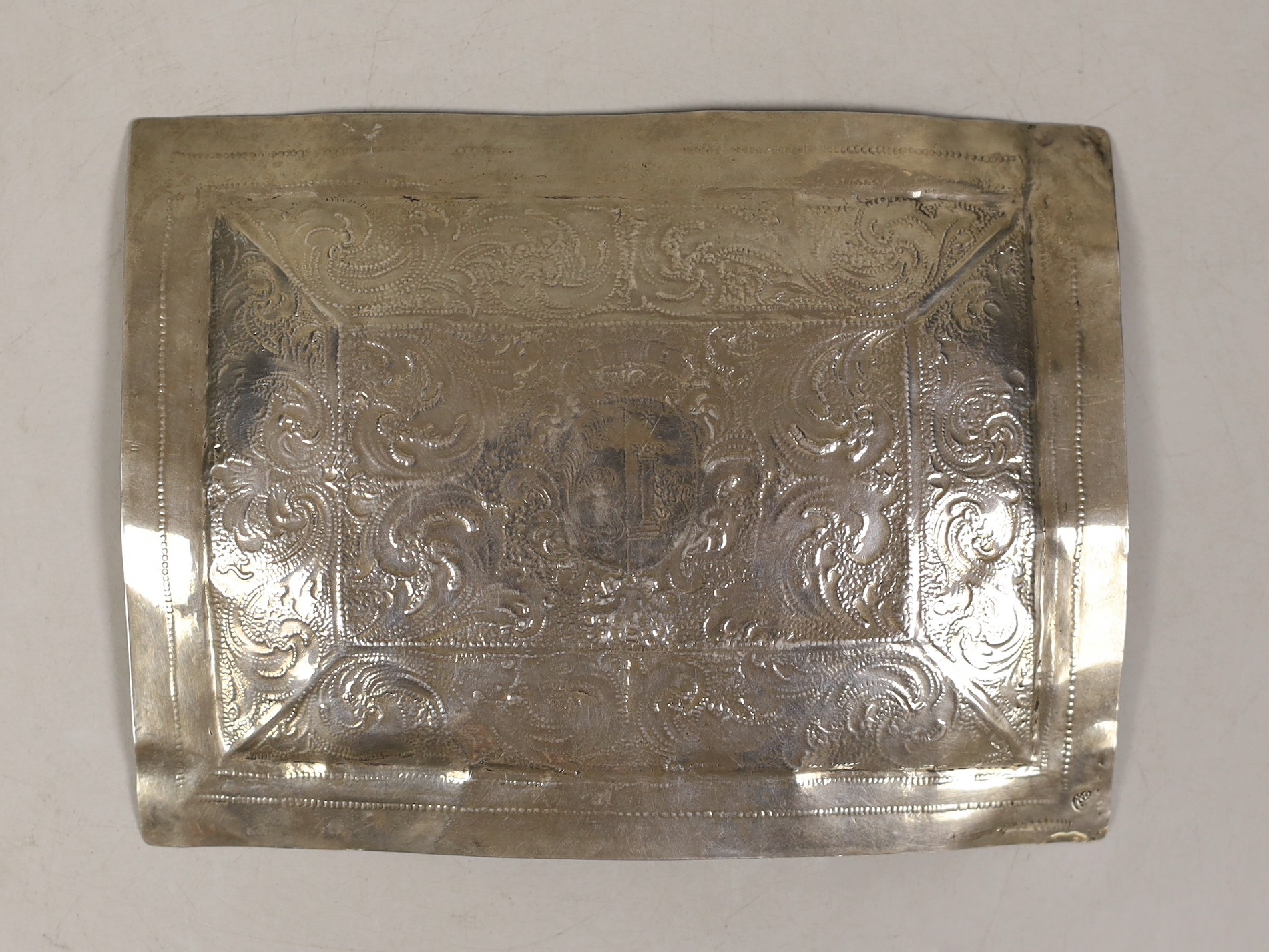 An 18th century? Italian white metal rectangular plaque, engraved with scrolls and central armorial, Rome mark, 14.7cm, 53 grams.